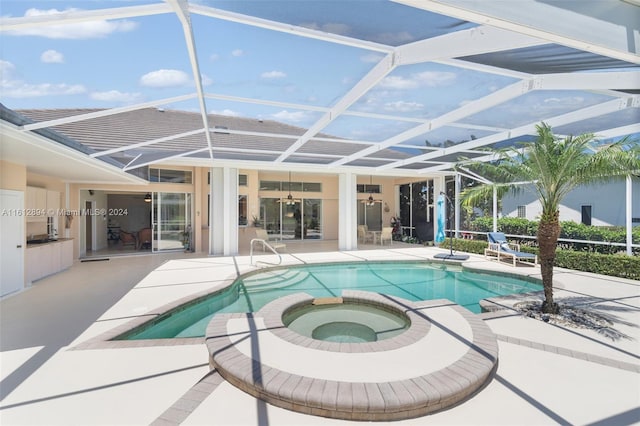 view of swimming pool featuring an in ground hot tub, a patio, and glass enclosure