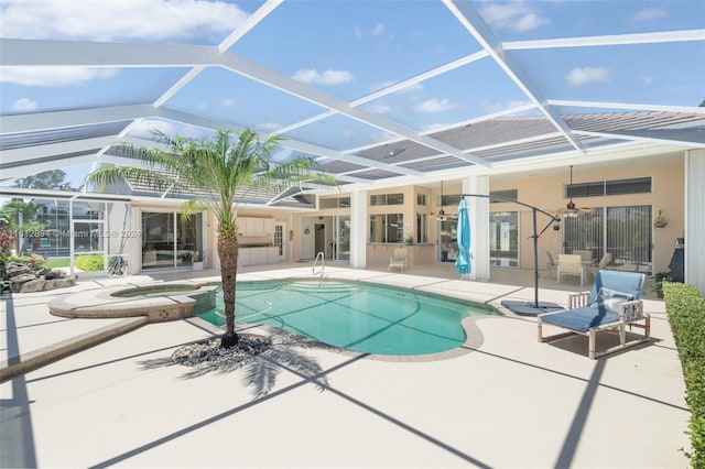 view of swimming pool featuring an in ground hot tub, a lanai, and a patio area