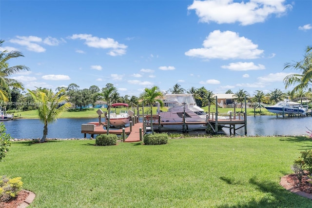 view of dock featuring a lawn and a water view