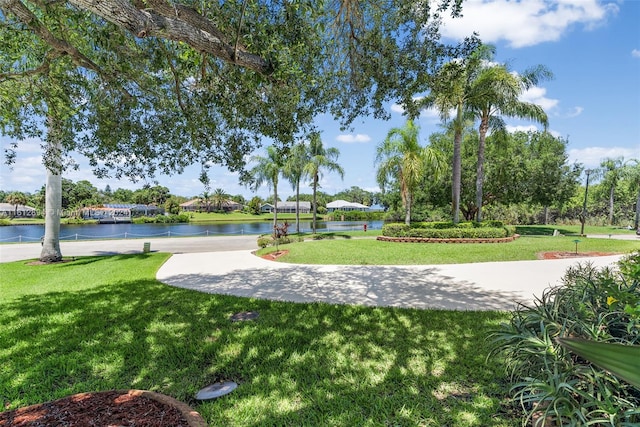 view of home's community featuring a yard and a water view