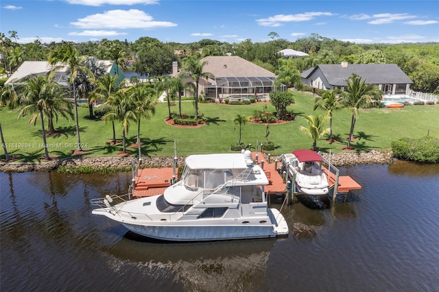 dock area with a lawn and a water view