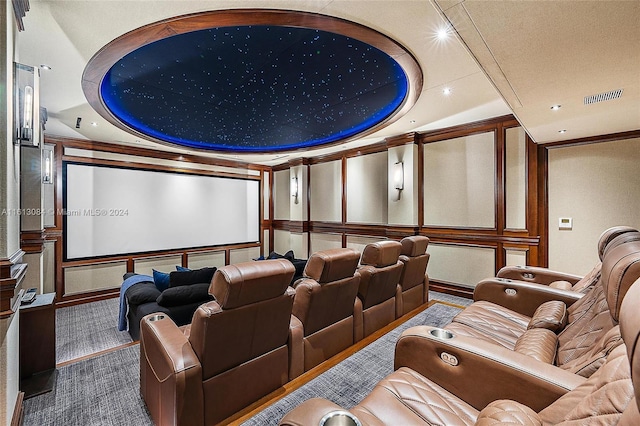 carpeted home theater with ornamental molding