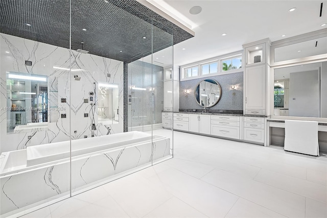 bathroom featuring vanity and separate shower and tub