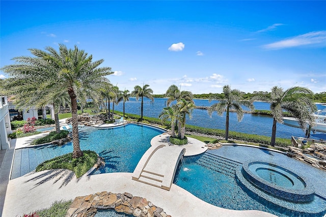 view of swimming pool with a water view, an in ground hot tub, and a patio