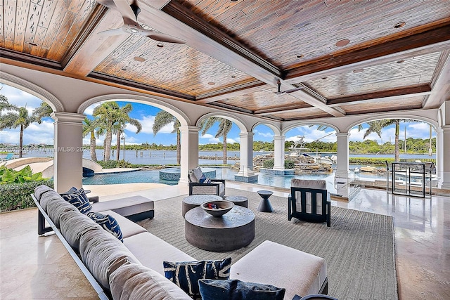 view of patio with outdoor lounge area, pool water feature, and a water view