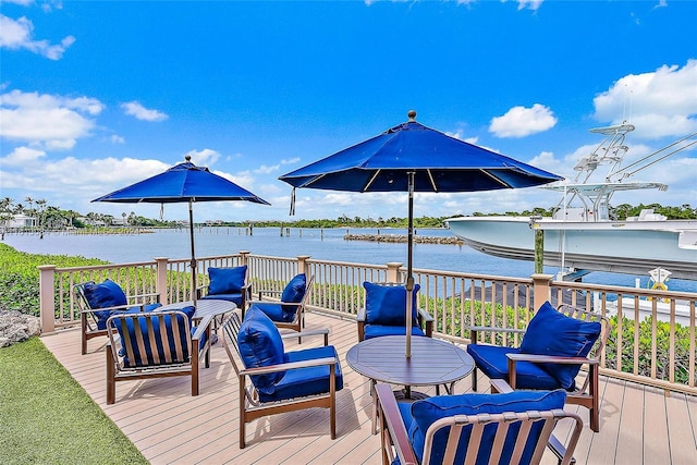 wooden deck with outdoor lounge area and a water view