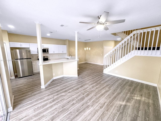 kitchen featuring stainless steel appliances, white cabinetry, ceiling fan, and light hardwood / wood-style floors