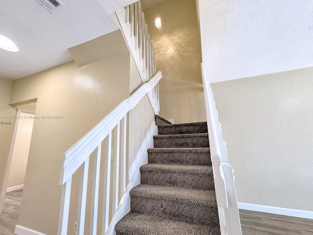 stairs with hardwood / wood-style flooring