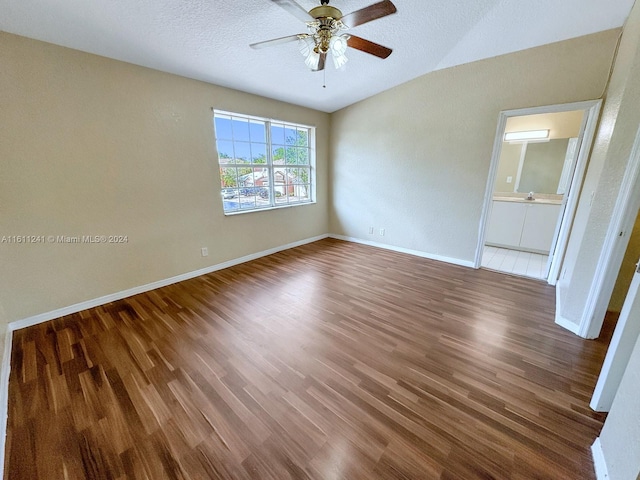 empty room featuring a textured ceiling, ceiling fan, and dark hardwood / wood-style floors