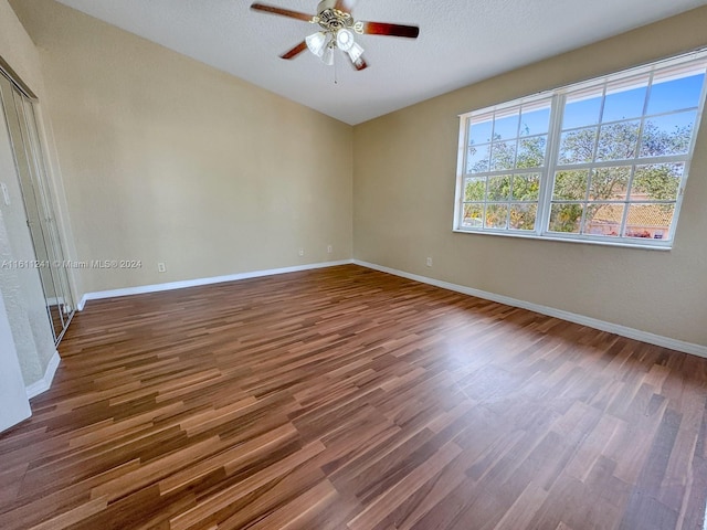 spare room featuring ceiling fan, hardwood / wood-style floors, and a textured ceiling