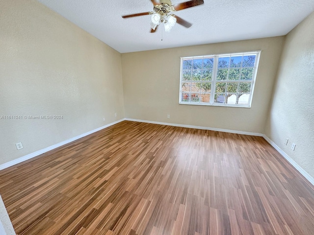 unfurnished room featuring hardwood / wood-style floors, a textured ceiling, and ceiling fan