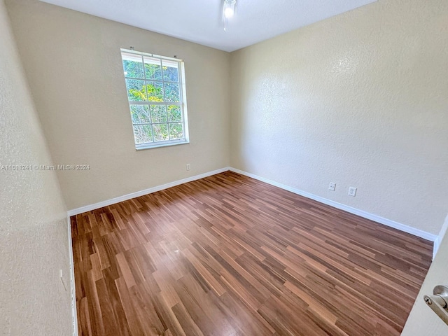 empty room with hardwood / wood-style floors