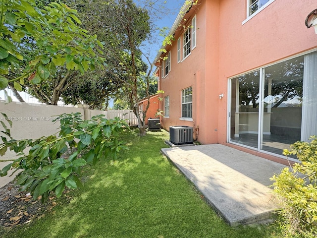 view of yard with cooling unit and a patio