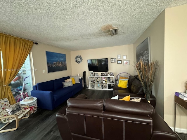 living room featuring a textured ceiling and dark hardwood / wood-style flooring