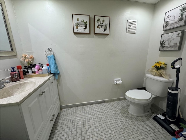 bathroom featuring tile patterned floors, vanity, and toilet