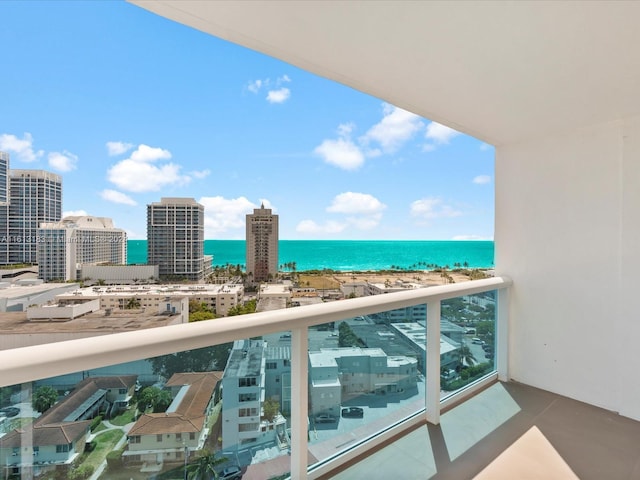 balcony featuring a city view and a water view