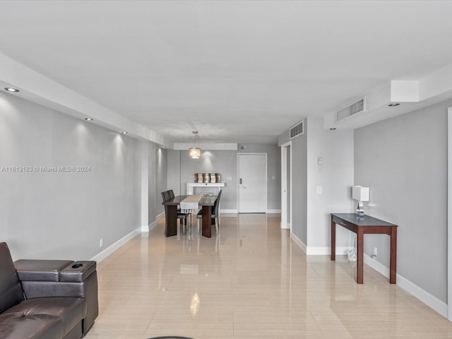 living area featuring baseboards and visible vents