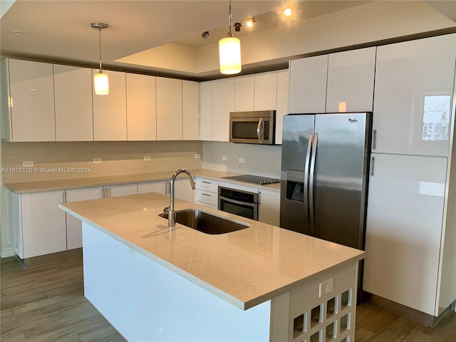 kitchen featuring white cabinetry, appliances with stainless steel finishes, and sink