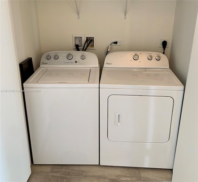 laundry room with hookup for a washing machine, hardwood / wood-style floors, hookup for an electric dryer, and independent washer and dryer