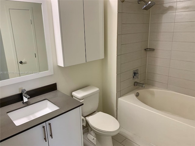 full bathroom featuring tiled shower / bath, vanity, and toilet