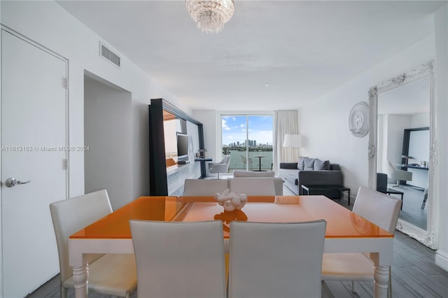 dining area featuring a notable chandelier and hardwood / wood-style flooring