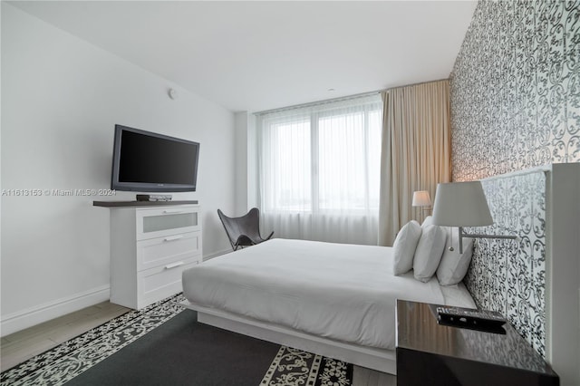 bedroom with wood-type flooring