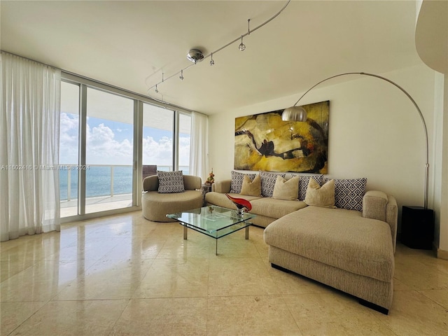 living room with floor to ceiling windows and a water view