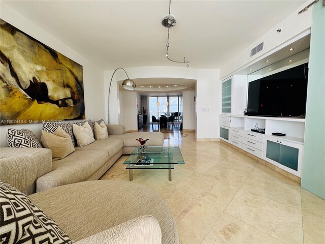 living area with light tile patterned floors and visible vents