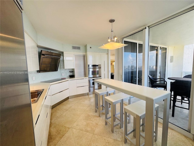 kitchen with double oven, white cabinets, black electric stovetop, visible vents, and modern cabinets