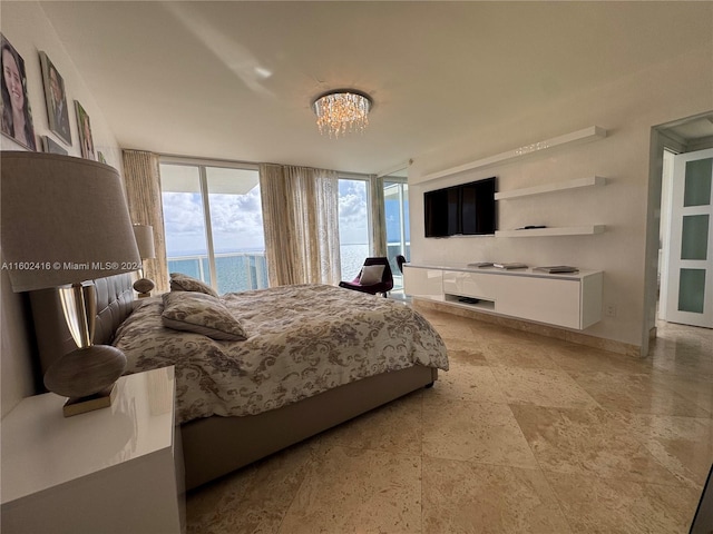 bedroom with access to outside, a wall of windows, and a chandelier
