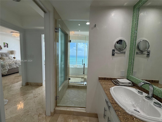 bathroom with a stall shower, ensuite bath, and vanity
