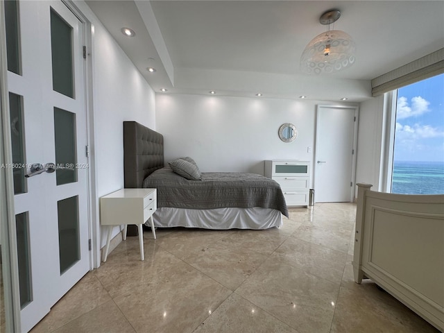 bedroom with recessed lighting and a water view