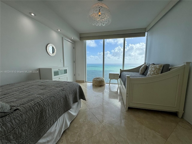 bedroom featuring access to outside and a water view