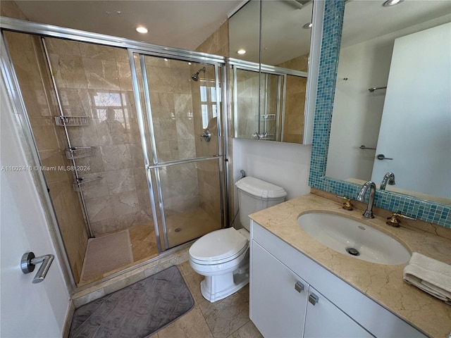 bathroom featuring toilet, vanity, a shower stall, and recessed lighting