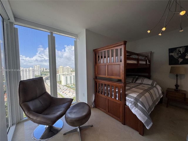 bedroom featuring floor to ceiling windows, a city view, and multiple windows