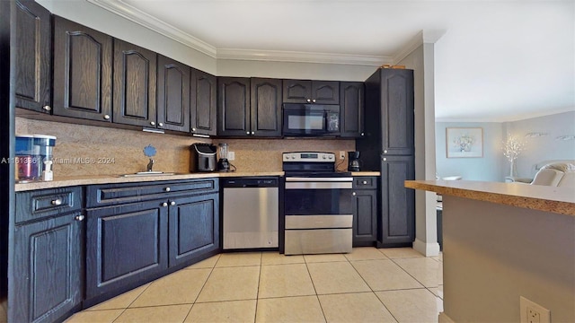 kitchen with appliances with stainless steel finishes, light tile patterned floors, tasteful backsplash, and ornamental molding