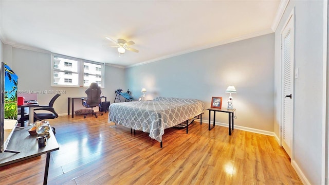 bedroom with ceiling fan, light hardwood / wood-style floors, and crown molding