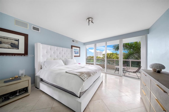 bedroom with access to outside and light tile patterned floors