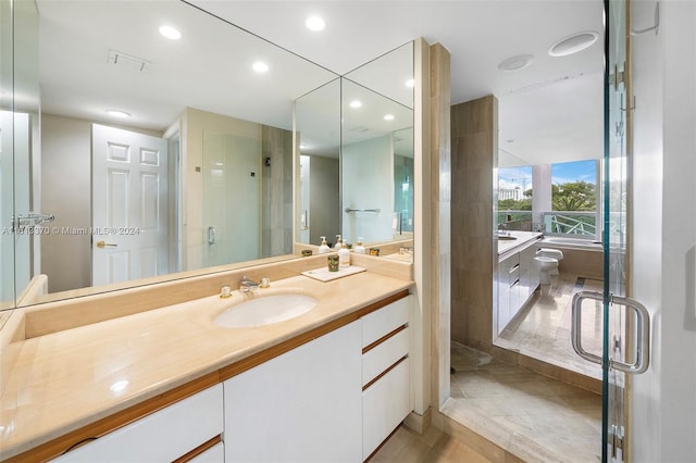 bathroom featuring vanity and a shower with shower door