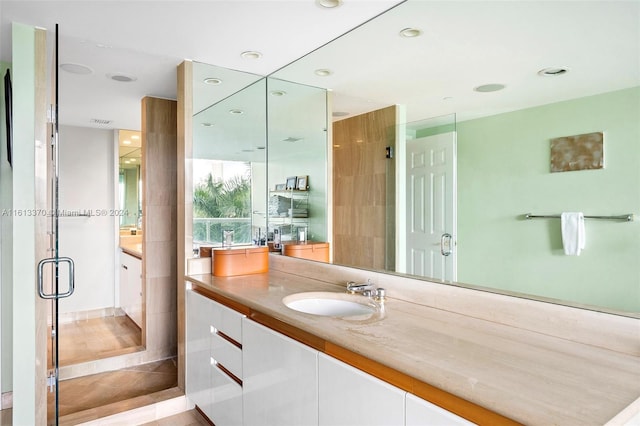 bathroom featuring vanity, tile patterned floors, and a shower with door