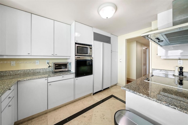 kitchen with island range hood, appliances with stainless steel finishes, white cabinets, and dark stone counters