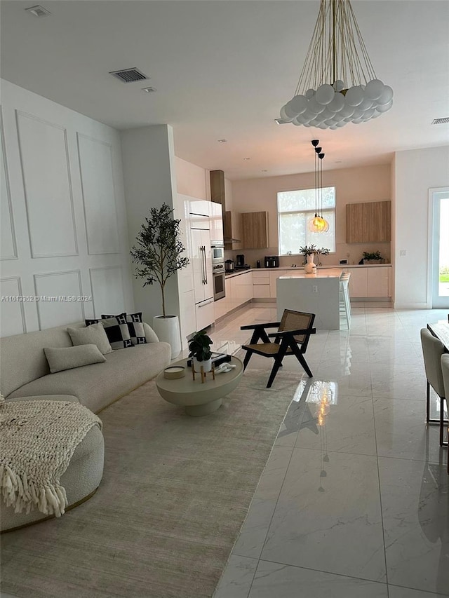 living room with a wealth of natural light and light tile floors