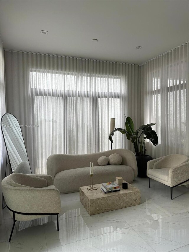 sitting room featuring a wealth of natural light and tile flooring