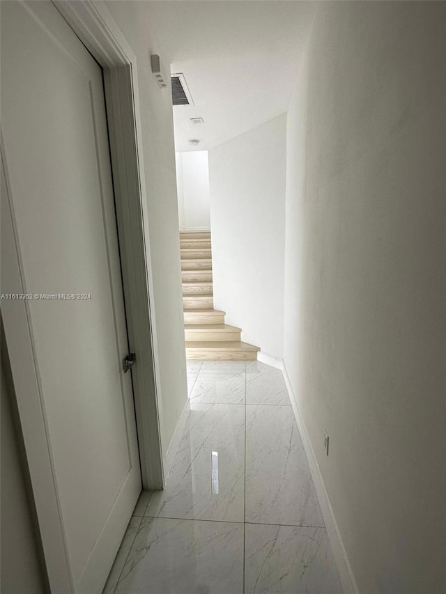 corridor with light tile floors