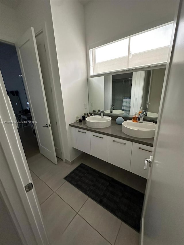 bathroom with tile flooring and dual vanity