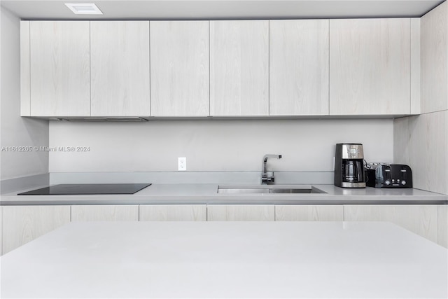 kitchen featuring sink and black electric cooktop