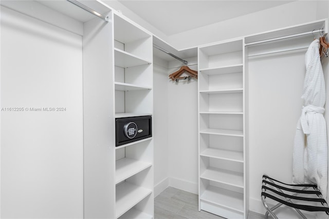 walk in closet with tile floors