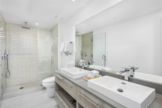 bathroom with walk in shower, tile flooring, toilet, and dual bowl vanity