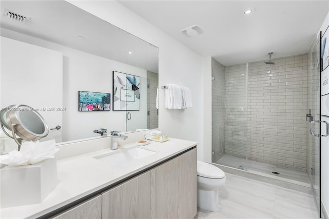 bathroom with a shower with shower door, toilet, tile floors, and large vanity