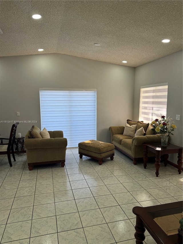 tiled living room with lofted ceiling and a textured ceiling